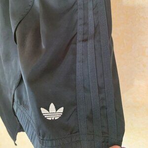 2/$40 adidas Asymetrical skirt with pockets and Silver embroidered Tri-foil logo